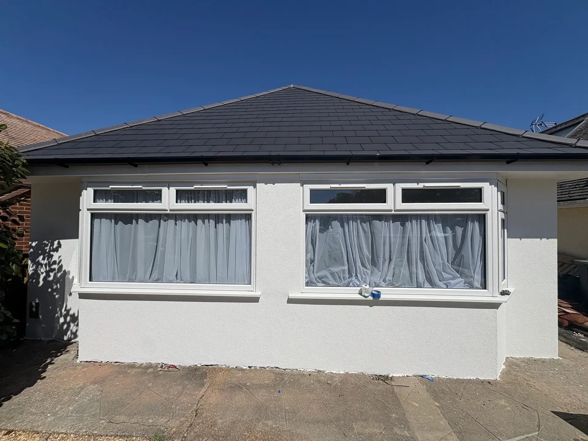 Pearl finished render on a coastal Dorset bungalow, blue sky